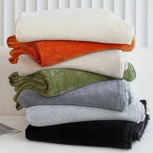 Thickened chenille waffle knit sofa cover blankets stacked in seven vibrant colors