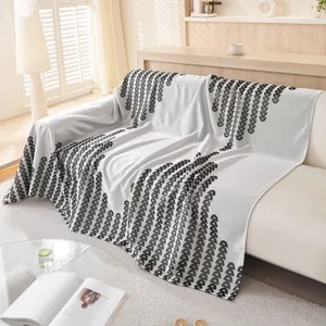 Summer ice silk sofa cover with black semi-circle patterns on a white knit blanket