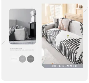 Detail of white cooling ice silk sofa cover with black geometric D pattern and frayed edges
