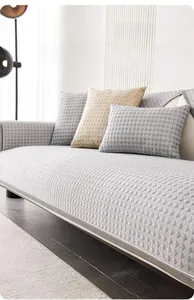 Detail view of grey summer cooling sofa mat with geometric diamond texture and neat piping