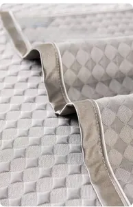 Macro detail of breathable grey summer cooling sofa mat with quilted diamond pattern