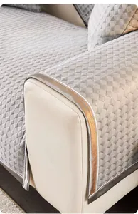 Detail of grey quilted cooling sofa mat featuring widened borders and durable metallic trim