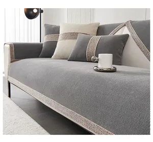 Detail of grey chenille sofa cushion with champagne gold woven lace and matching pillow