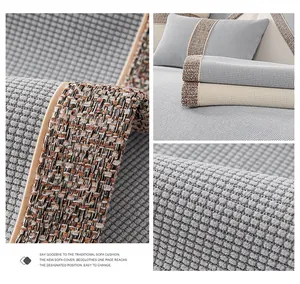 Close-up of grey waffle weave sofa cover with bohemian fringe and premium fabric texture