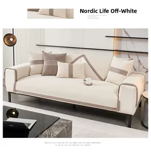 Detail of creamy white chenille sofa cushion with textured border in modern living room