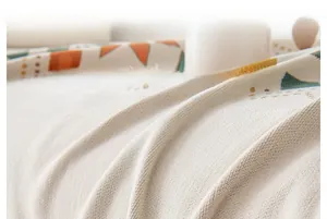 Detail shot of beige chenille fabric with woven geometric patterns and soft texture