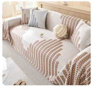 Detail of beige ice silk sofa cover featuring jacquard letter pattern and luxury texture