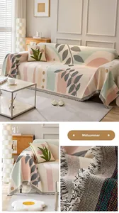 Detail of woven cotton sofa cover featuring leaf patterns and decorative tassel fringe