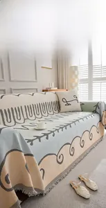 Detail of Nordic knit sofa cover with modern wavy patterns and stylish short fringes