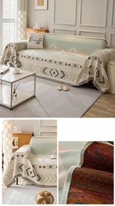 Close-up of geometric woven sofa throw cover with tassels and mint green fabric texture