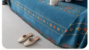 Detail of bohemian chenille sofa cover showing geometric diamond patterns and fringe edges