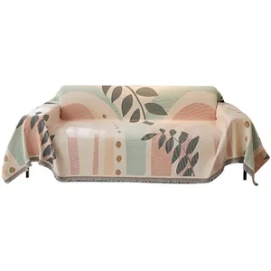 Modern chenille sofa cover with abstract botanical patterns and fringe edges