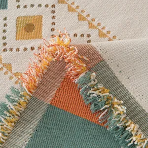 Bohemian chenille sofa cover with geometric patterns and colorful tassel edges