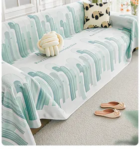 Close-up of cool silk sofa cover with green cactus pattern and be together text
