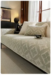 Detail of light green French chenille sofa cushion with diamond floral pattern texture