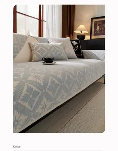 Close-up of light blue chenille sofa cover with floral jacquard texture and cushions