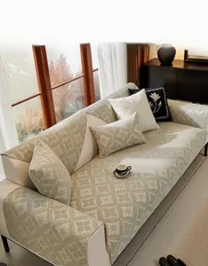 Detail of green chenille sofa cover with white geometric floral jacquard fabric