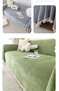 Close-up of herringbone texture and pom-pom tassel fringe on chenille sofa cover