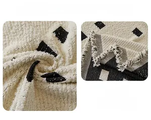 Macro detail of plush white boucle sofa cover fabric with black checkered pattern and tassels