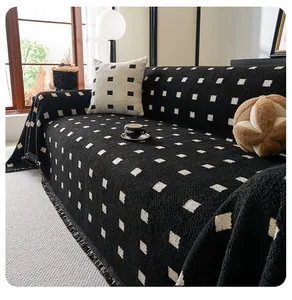 Close-up of thick chenille textured sofa cover with black white plaid and tassels