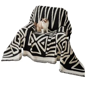 Bohemian knit sofa cover blanket with black and white geometric tribal patterns and tassels