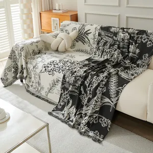 Floral chenille sofa cover with black and white jacquard patterns and fringed edges