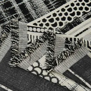 Luxurious chenille sofa cover with black and white geometric patterns and tassel edges