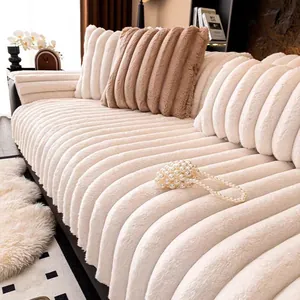 Close-up of thick striped faux rabbit fur sofa cushion with soft plush texture in cream white