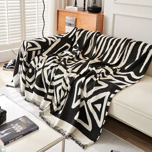 Bohemian chenille throw blanket with black and white geometric patterns and fringe