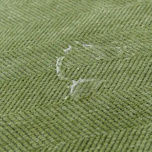 Waterproof green herringbone chenille sofa cover with hydrophobic texture detail