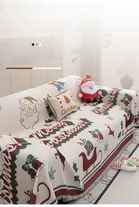 Close-up of festive Chenille sofa cover with red Santa patterns and elegant tassel edge