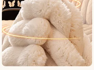 Close-up of soft white faux rabbit fur sofa cover with plush texture and warm lighting