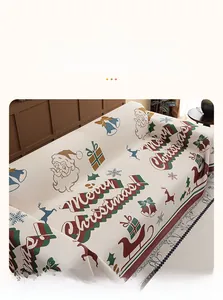 Close-up of festive chenille sofa cover showing woven Christmas patterns and fringe edges