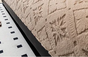 Close-up of beige plush sofa cover with thick diamond quilted pattern and snowflake tufting