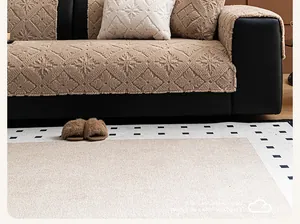 Detailed close-up of brown plush sofa cushion with embossed snowflake pattern texture