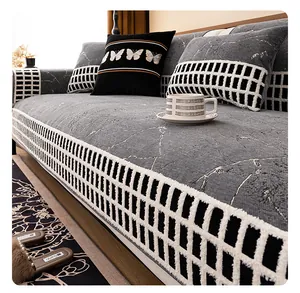 Detail of chenille sofa cover with grey marble pattern and black-white checkered border