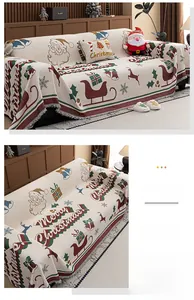 Detail of washed cotton Christmas sofa throw featuring reindeer and Santa Claus patterns