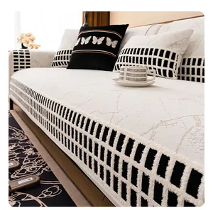 Detail of chenille sofa cushion with marble texture and black-white checkered plush edges