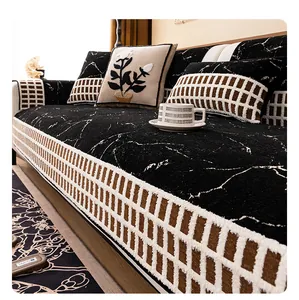 Detail of black chenille sofa cover with marble pattern and woven edge in modern living room