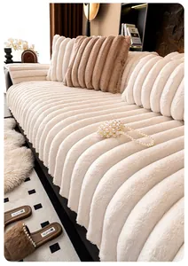 Detail of thick cream faux rabbit fur sofa cushion with vertical stripe texture