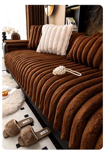 Detail of thick dark brown rabbit fur texture with striped corduroy pattern on sofa cover