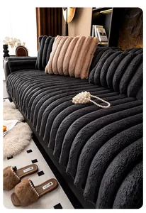 Detail of thickened faux rabbit fur sofa cover with vertical quilted stripes and soft texture