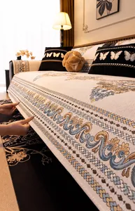 Close-up of chenille sofa cover showing thick jacquard weave and vintage floral embroidery