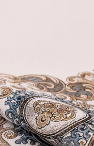 Detailed macro view of Chenille sofa cover with vintage blue and gold floral pattern