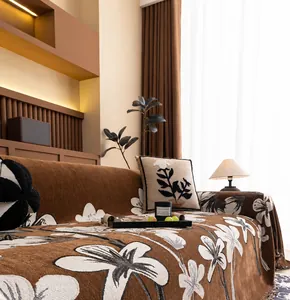 Close-up of luxury chenille sofa cover with floral patterns and decorative tassels