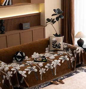 Detail of chenille fabric texture with floral patterns and delicate tassels on sofa cover