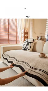 Detail of chenille sofa cushion with herringbone weave and scalloped stripe edge