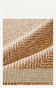 Macro detail of high-density chenille fabric with a beige herringbone weave pattern