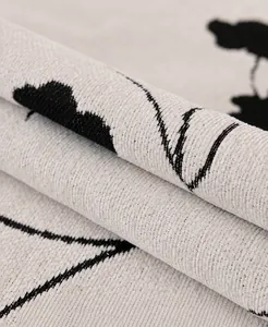 Macro detail of chenille sofa cover fabric featuring silver thread and botanical pattern