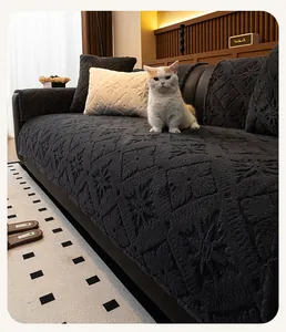 Detail of dark plush sofa cover with embossed diamond patterns and thick fabric texture